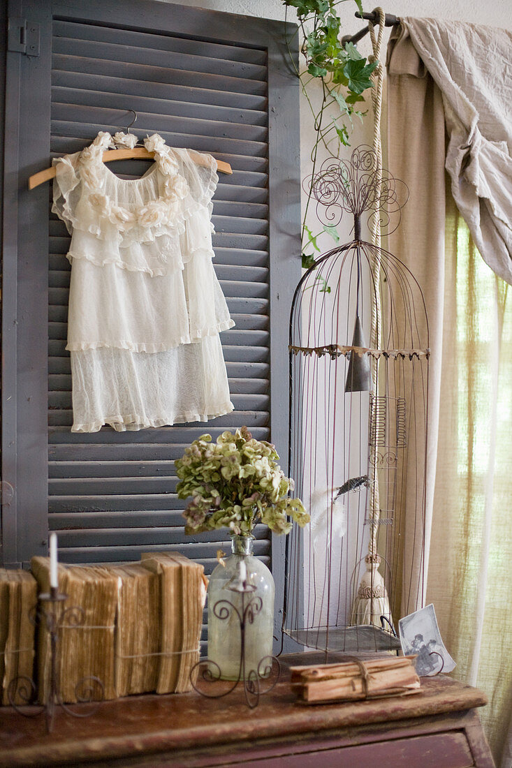 White shirt on window shutter surrounded by nostalgic decorations