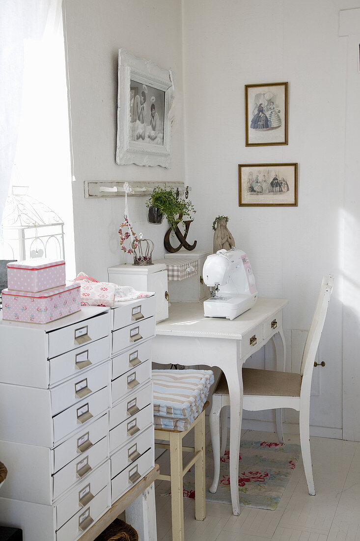 Chest of drawers next to sewing table in shabby-chic style