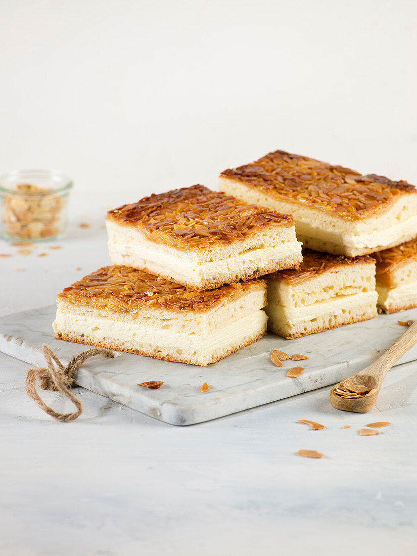 Slices of Bienenstich (caramelised almond cake) on a marble board