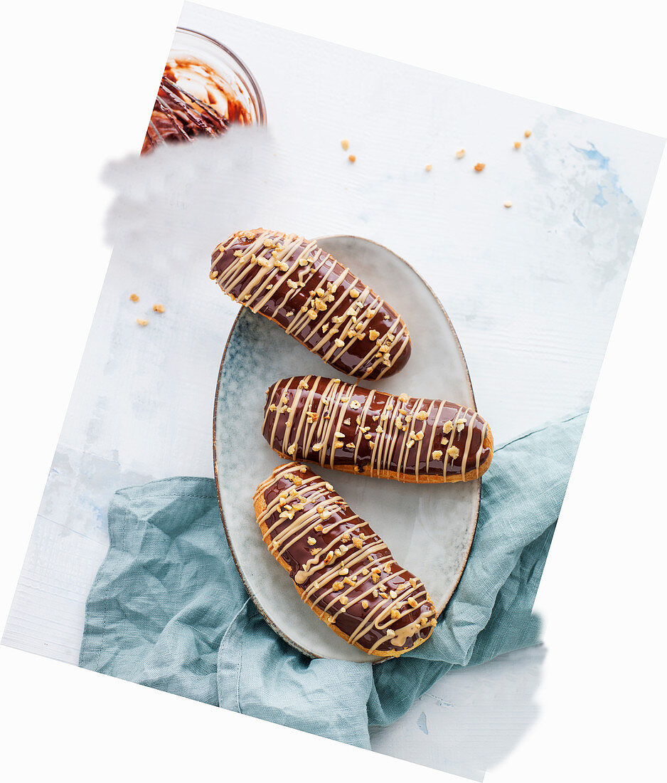 Hazelnut and caramel eclairs on an oval plate