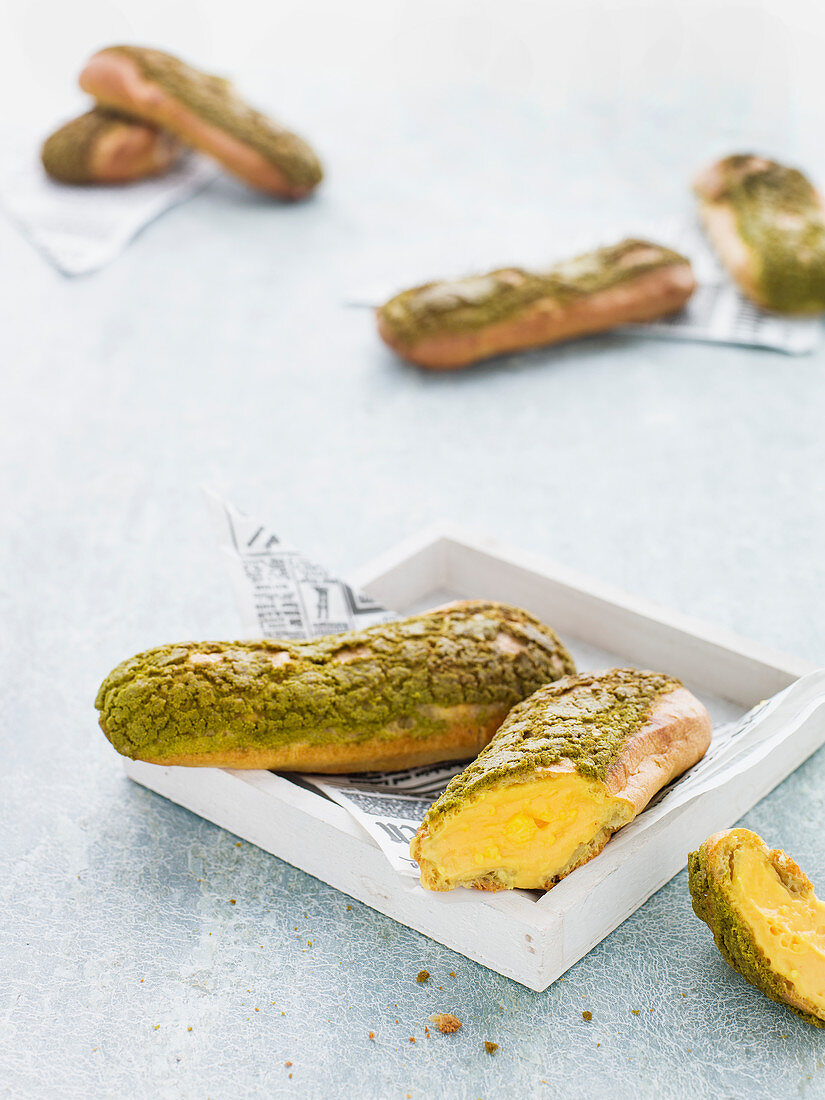 Matcha eclairs with a passion fruit filling