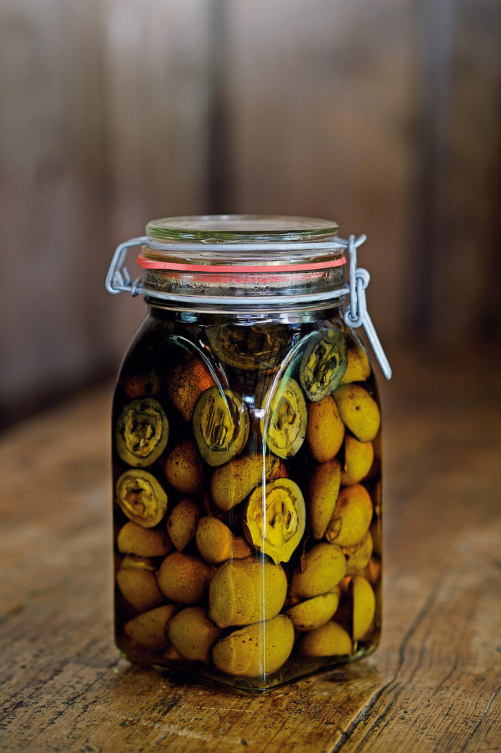 Pickled candied walnuts in a flip-top jar