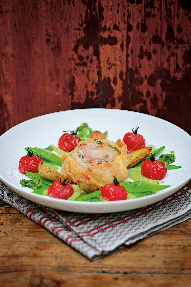 Saddle of rabbit in strudel pastry with braised tomatoes