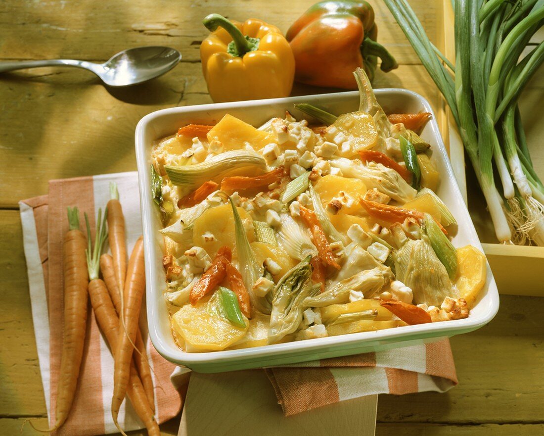Summer vegetable casserole with sheep's cheese in square dish