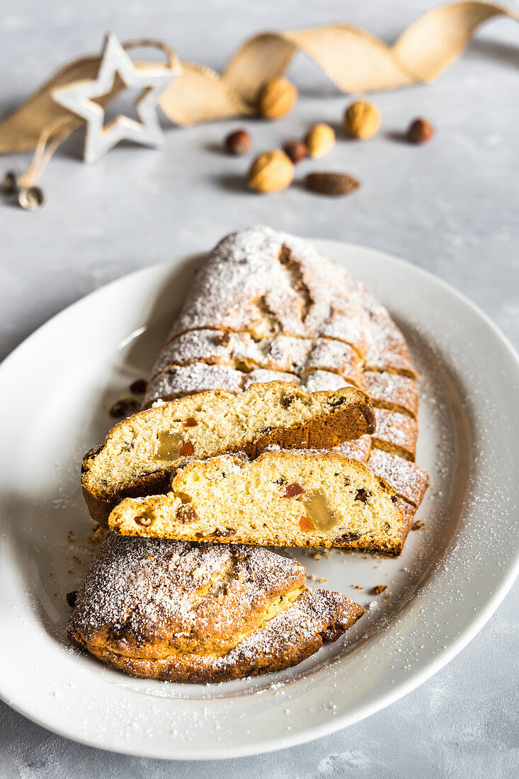 Traditional Christmas Stollen cake with marzipan and candied fruit