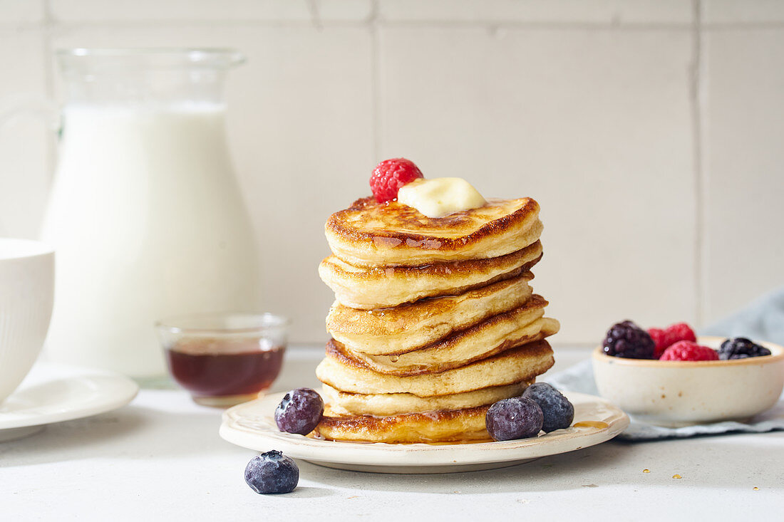 Pancakes with maple syrup, butter and berries