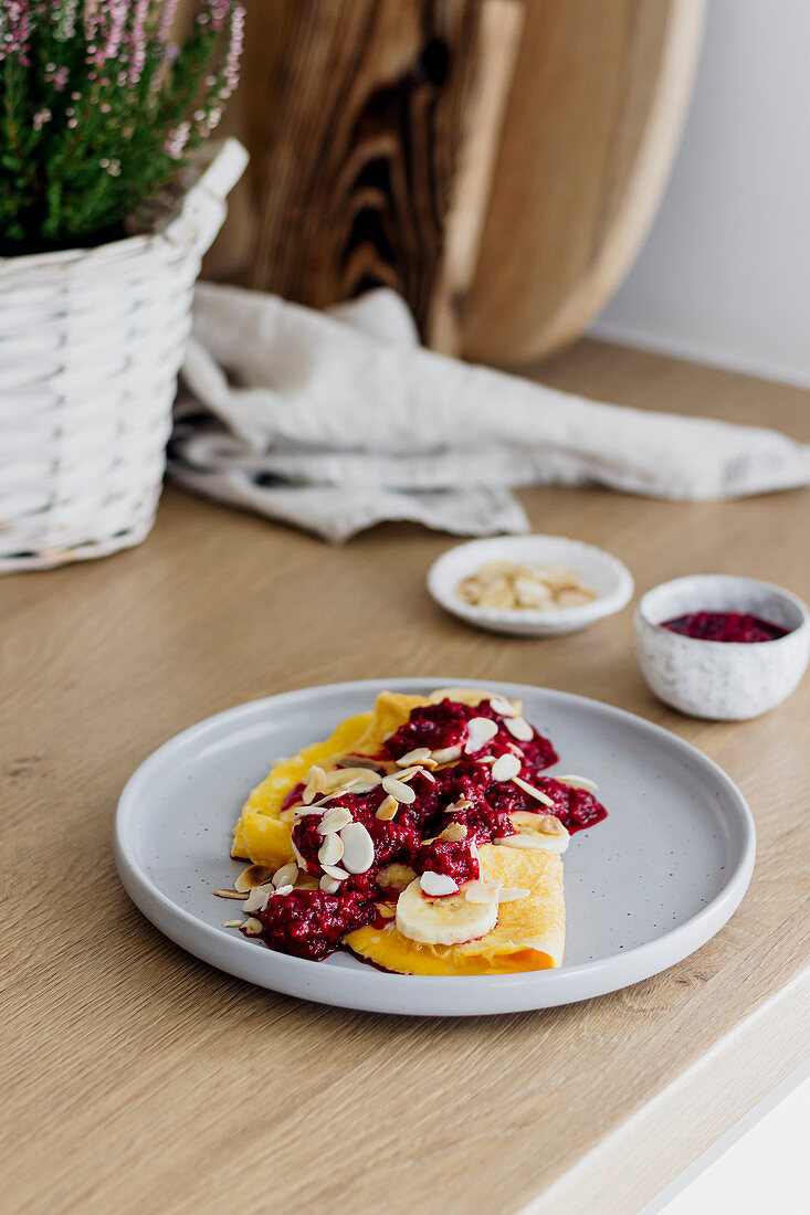 A sweet omelette with raspberries, bananas and almonds