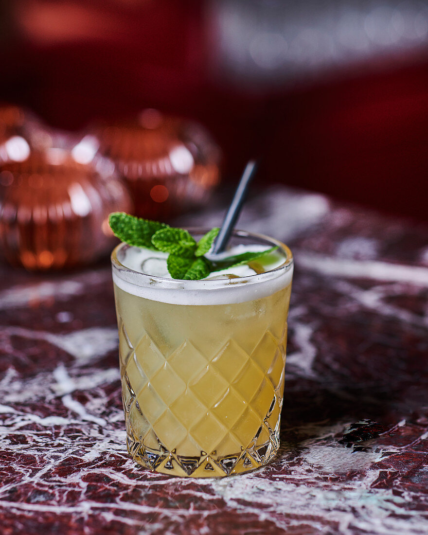 A cocktail made with rum, pineapple juice and mint