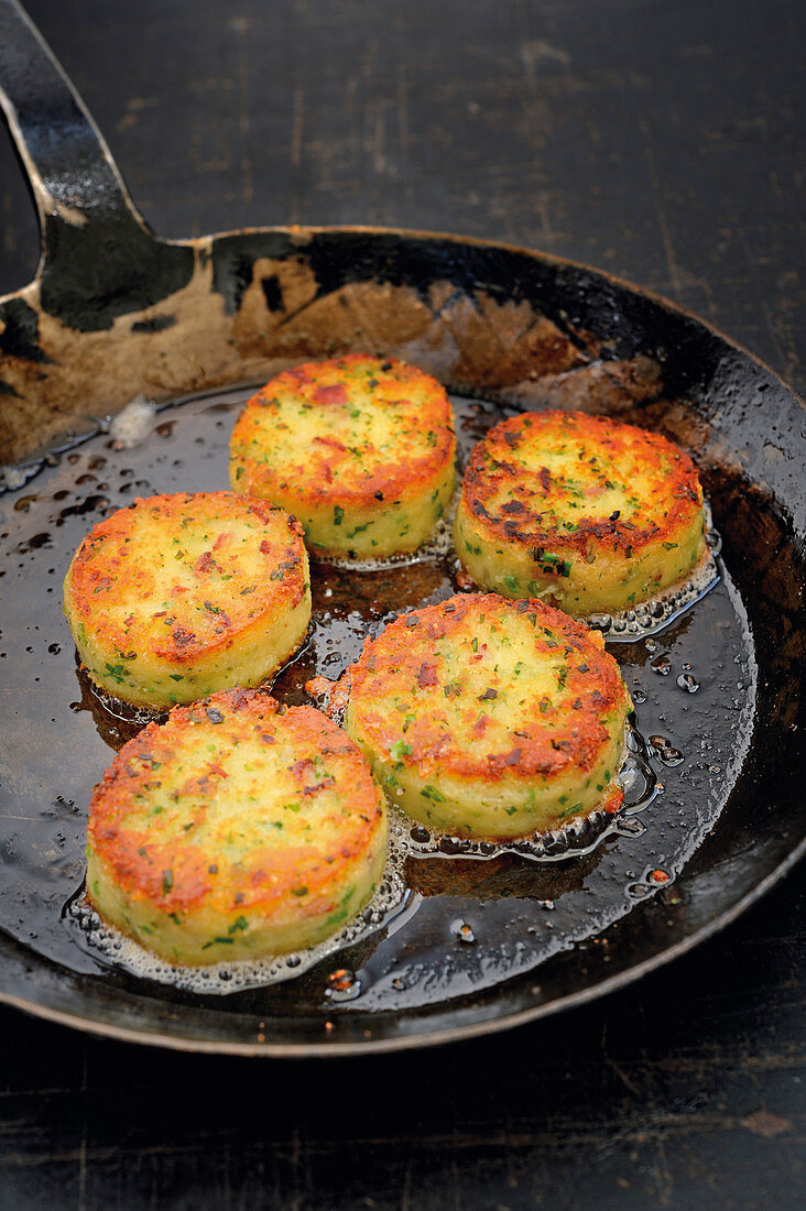 Macaire potatoes being fried in a pan