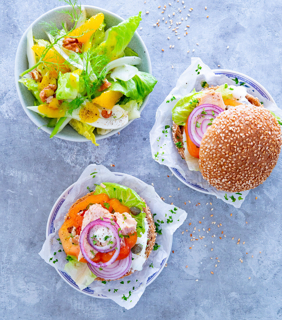 Tuna burger in a sesame seed bun with a fennel and orange salad