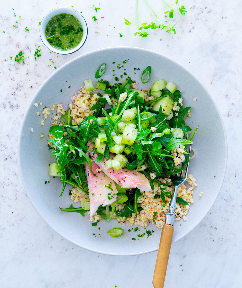 Millet salad with smoked trout, rocket and cucumber