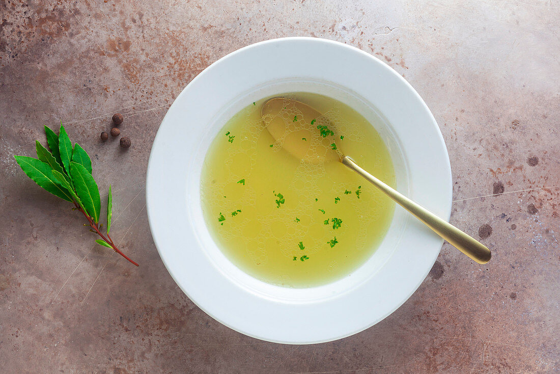 A bowl of clear chicken broth