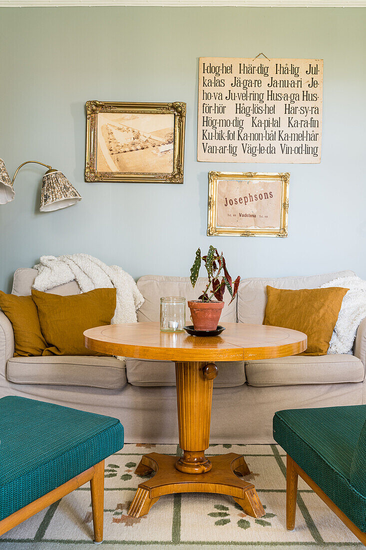 Pedestal table in living room decorated with flea-market finds