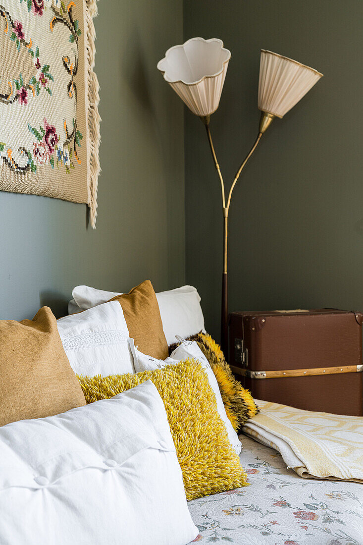 Various cushions on couch in room decorated with flea-market finds