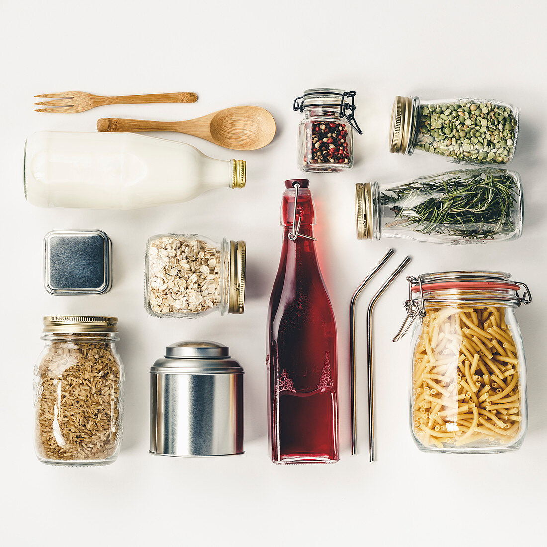 Glass and metal jars with beans, pasta, lentils, milk, juce