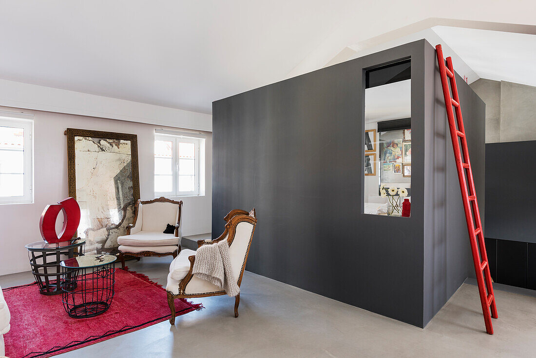 Red ladder on grey wall in living room