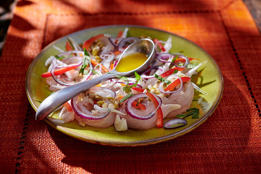 Marinated sea bass fillets with red onions