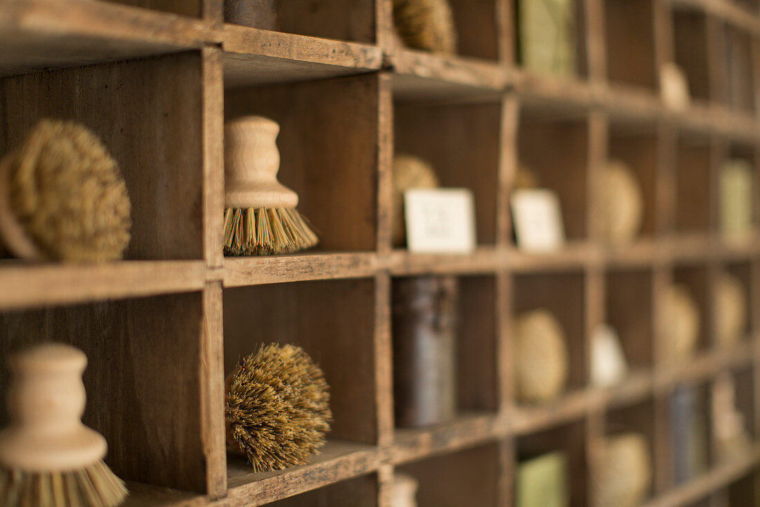 Vintage wooden bristle brushes in wood display cubbies