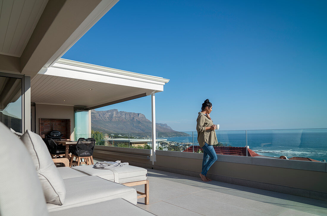 Woman enjoying coffee on balcony