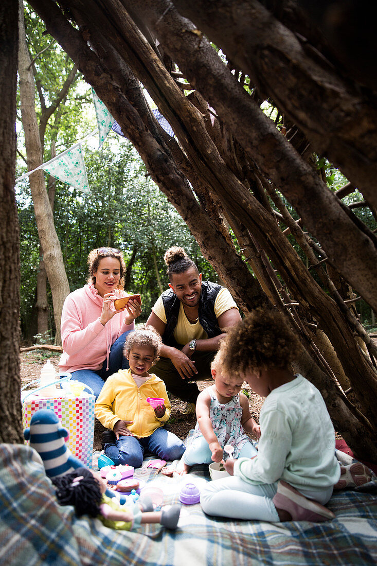 Family enjoying tea party in fort outdoors