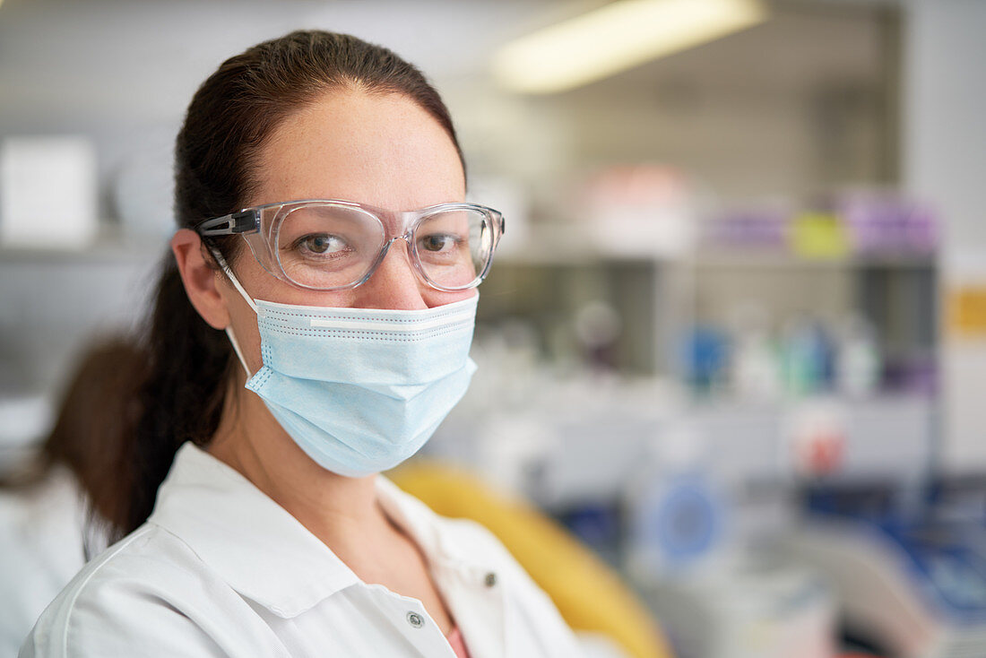 Portrait confident scientist in face mask in laboratory