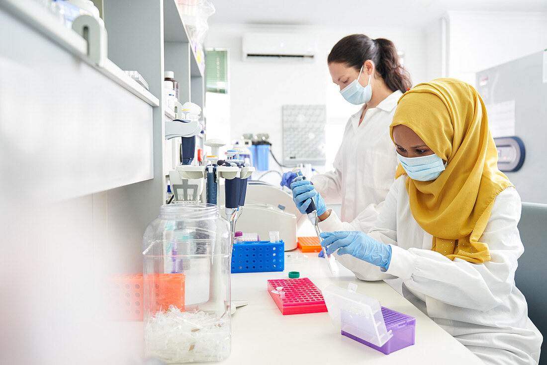 Scientists in face masks and hijab working