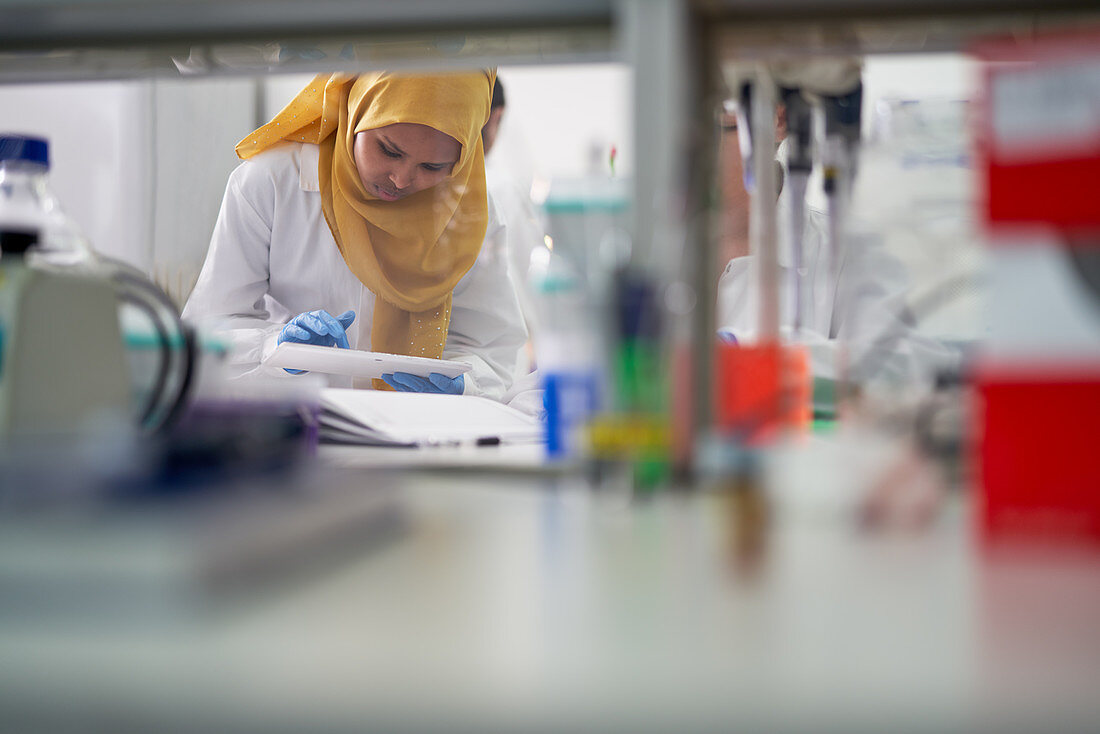 Scientist in hijab with digital tablet
