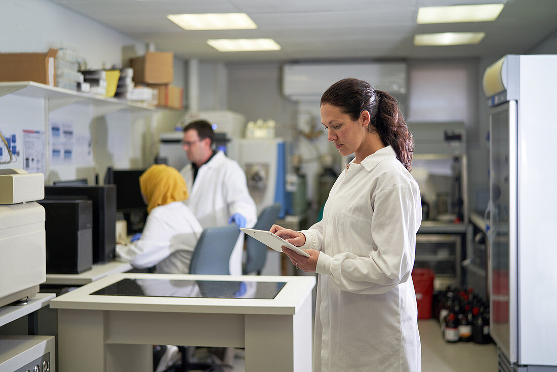 Female scientist using digital tablet in laboratory