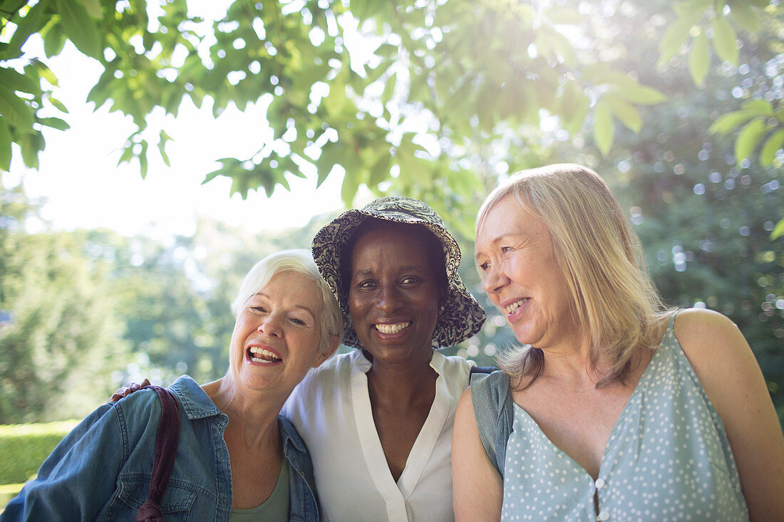 Portrait happy senior women in sunny summer garden