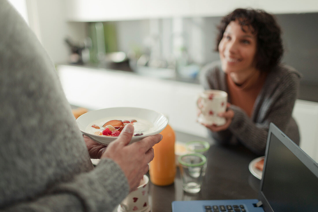 Couple eating breakfast and talking