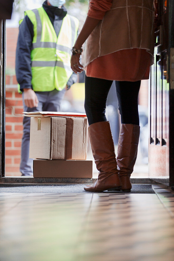 Woman receiving packages from delivery person