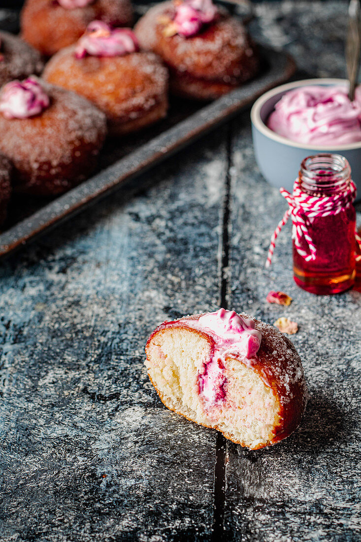 Vegan donuts with rose cream and jam