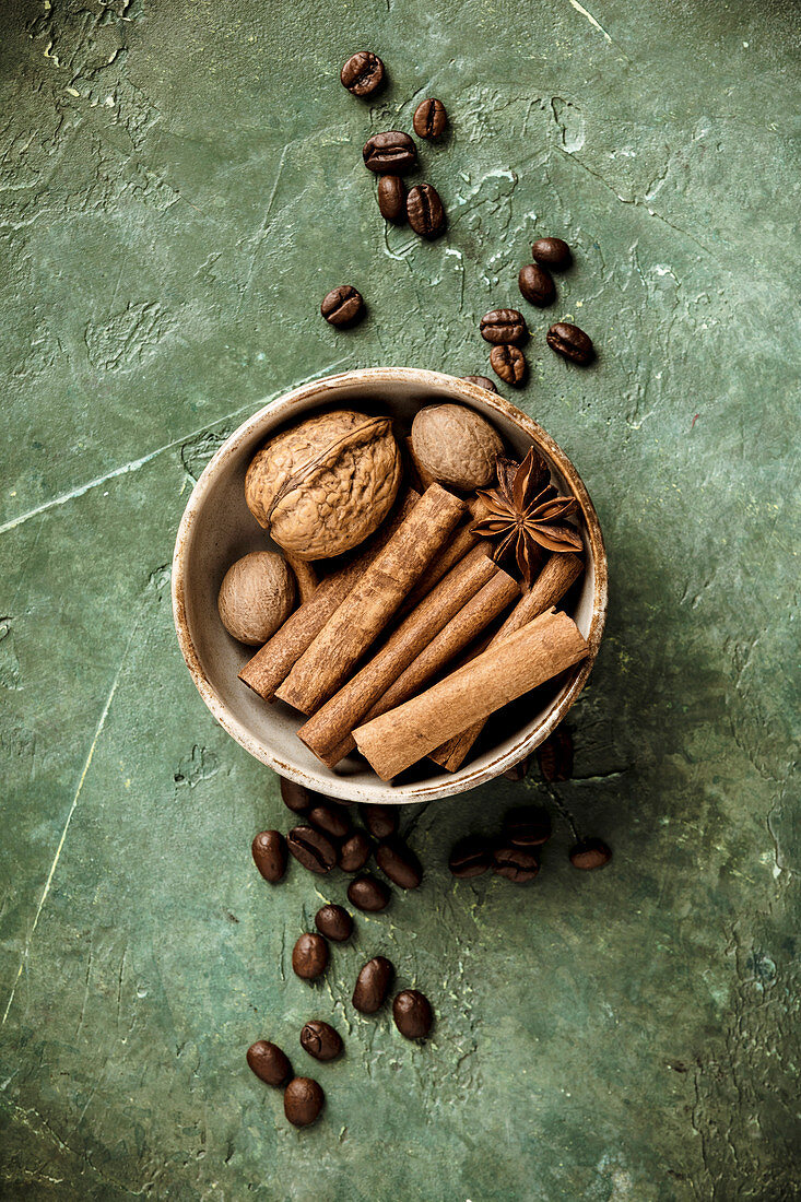 Walnut, spices and coffee beans on rustic background