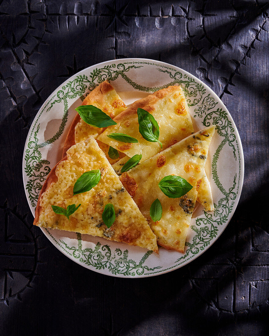 Three cheese pizza with basil