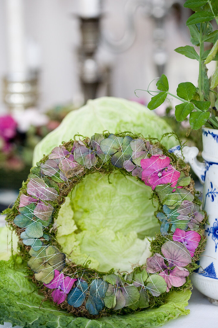 Wreath made of moss and hydrangea blossoms in different colors