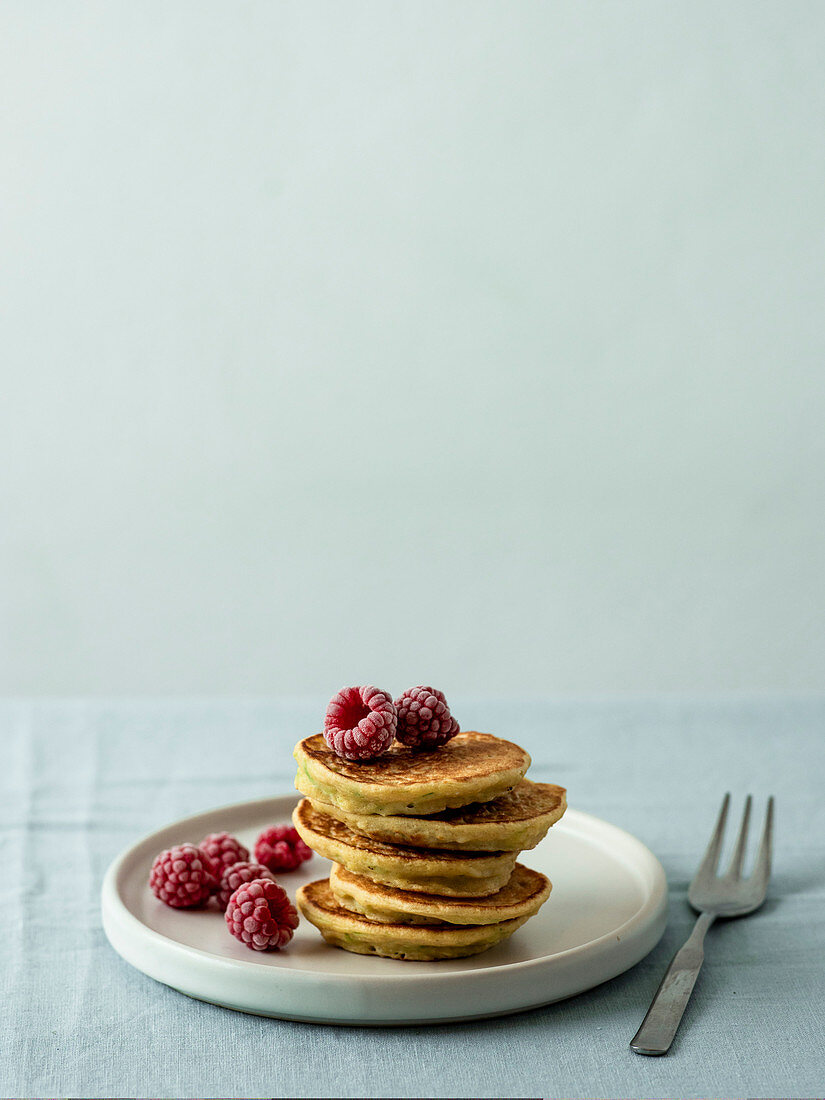 Gluten-free zucchini pancakes with corn flour and raspberries