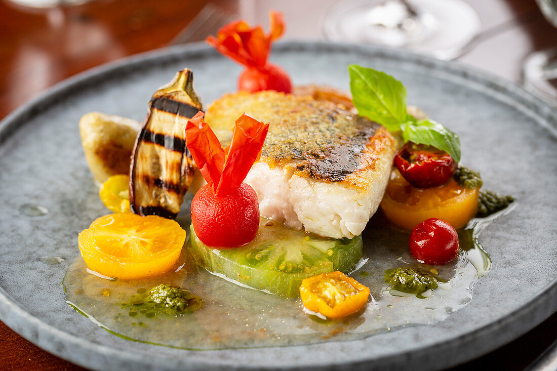 Fried fish with coloured tomatoes