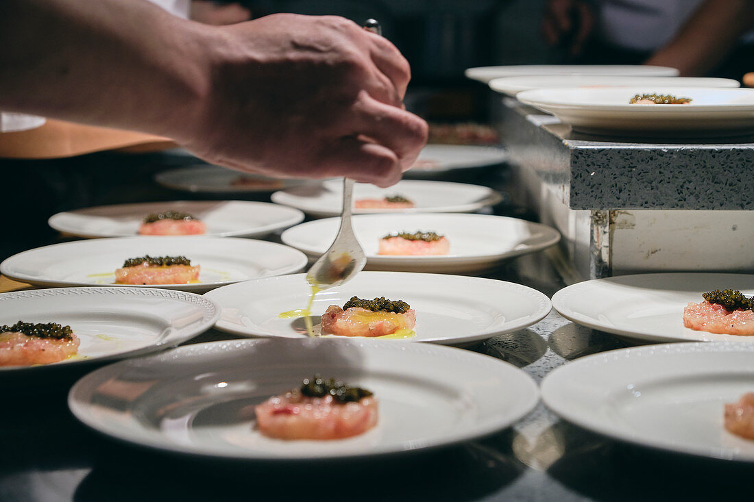 Chefs preparing dishes in French restaurant