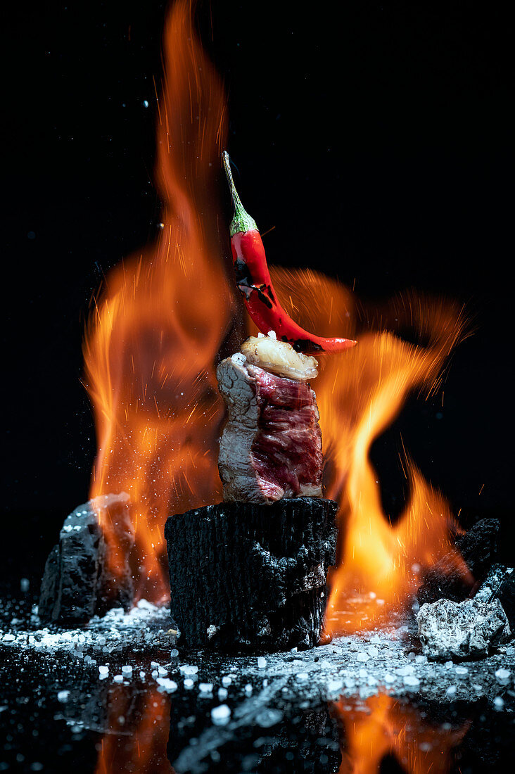 Beef fillet placed on charcoal piece