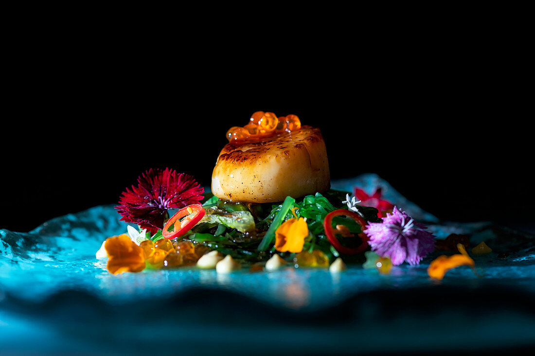 Scallop with caviar, green noodles and flowers petals