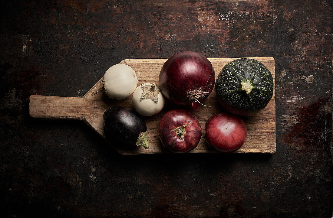 Assorted vegetables on wooden board