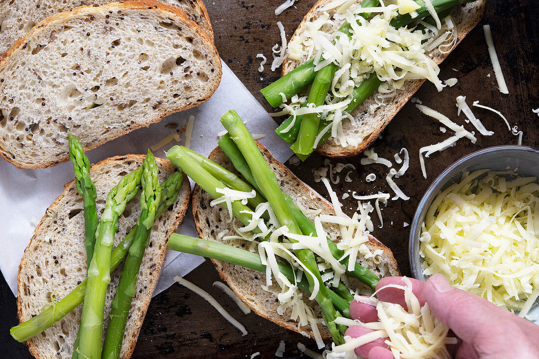 Cheese sprinkled over asparagus on wholegrain sourdough bread