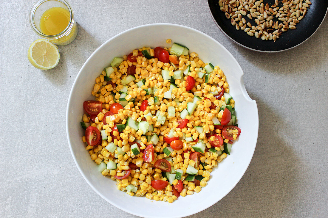 Sweetcorn salad with tomatoes, cucumber and pine nuts