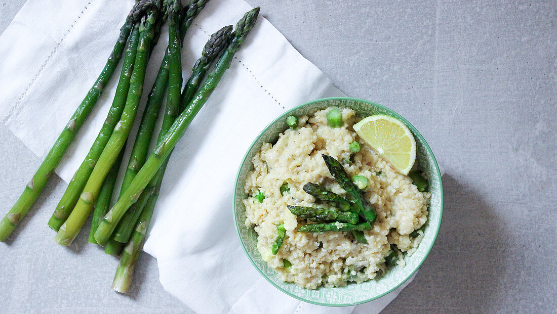 Lemon millet with green asparagus and Parmesan cheese
