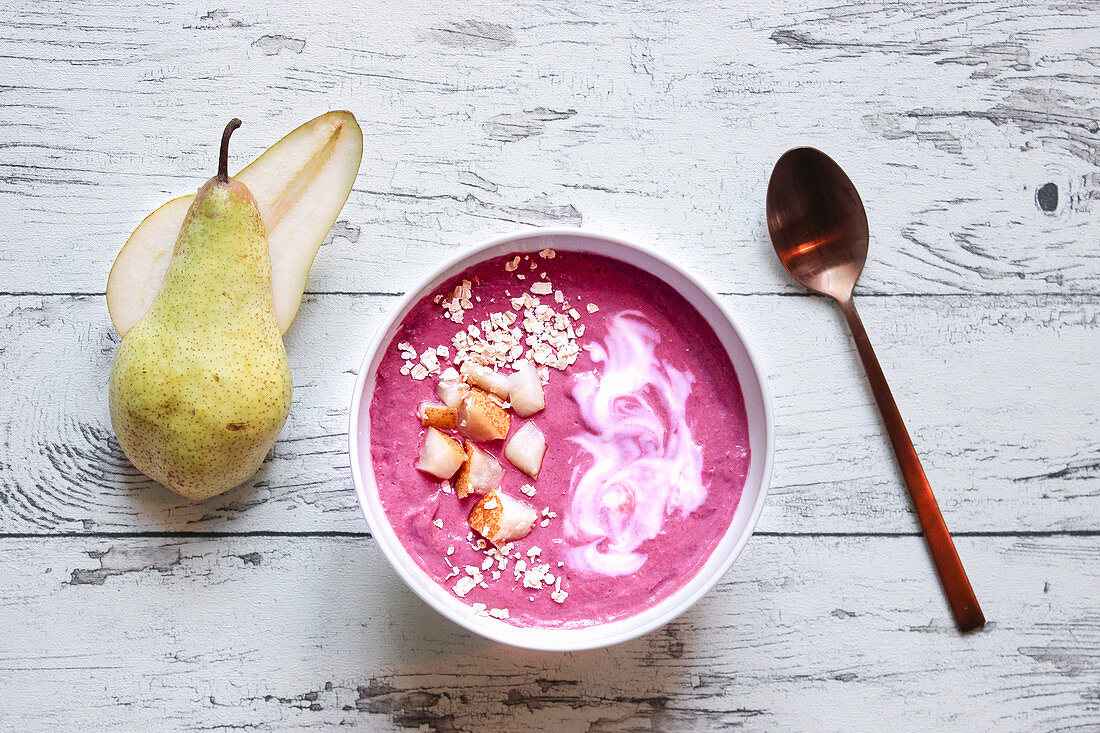 A pink smoothie bowl made with beetroot, banana and soya yoghurt