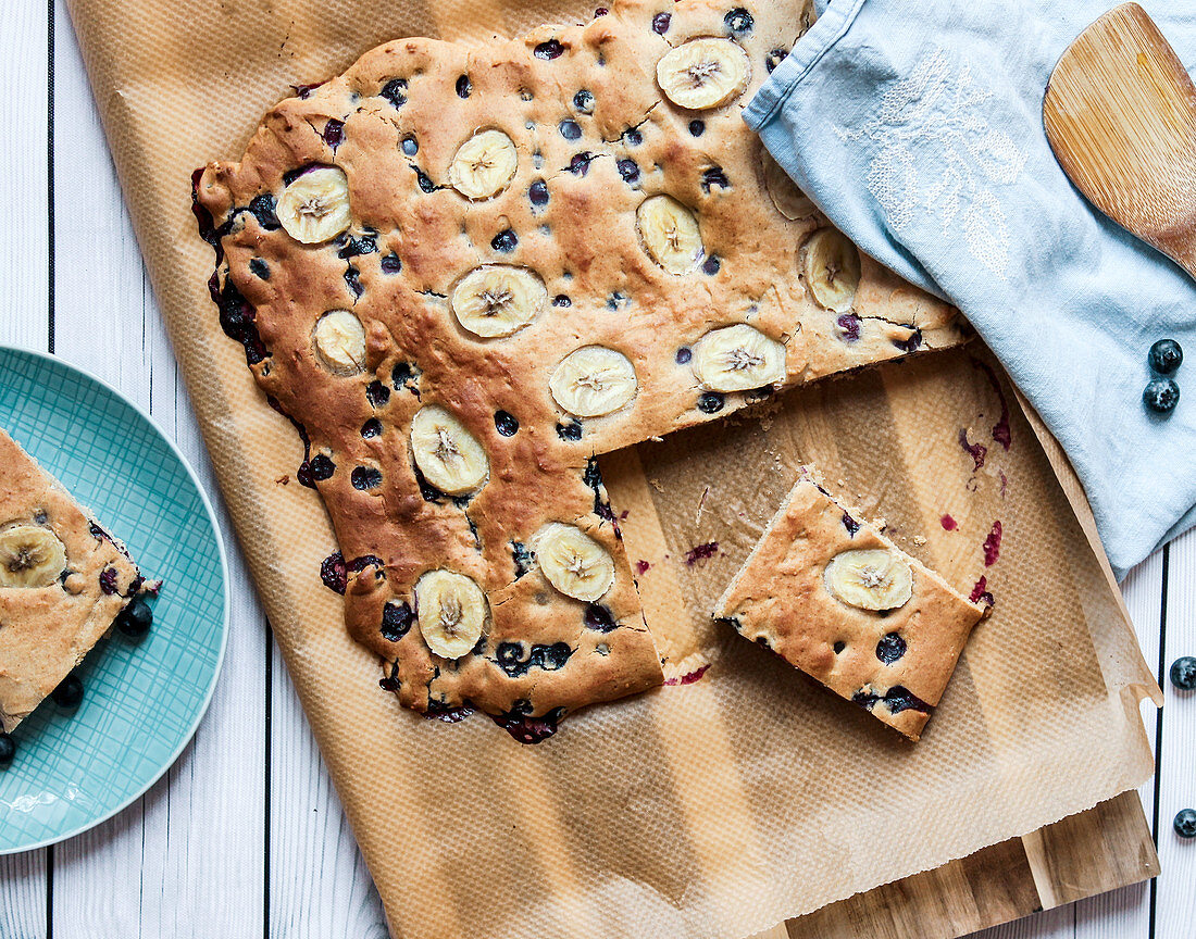 A tray bake pancake with bananas and blueberry