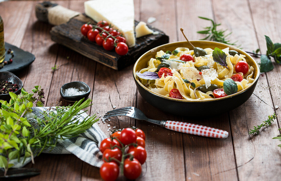 Tagliatella with herbs, small tomatoes and parmesan