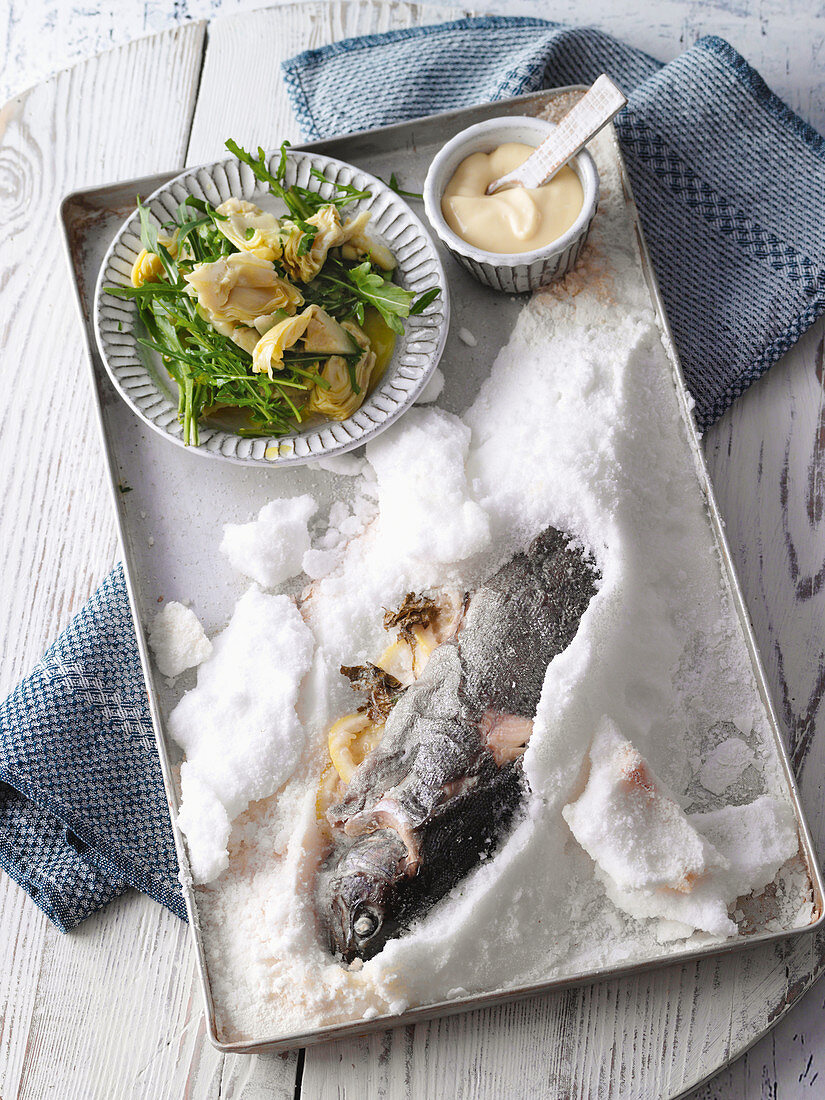 Salt-crusted trout with artichoke salad and aioli