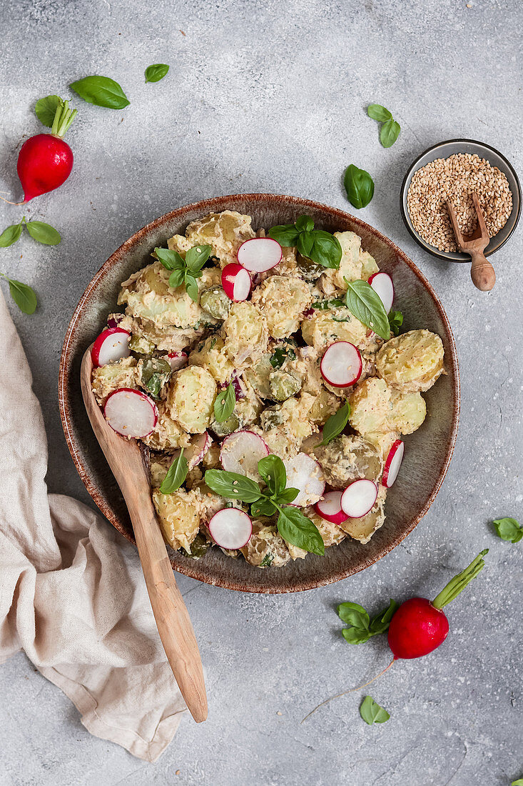 Vegan herb and sesame potato salad with radishes