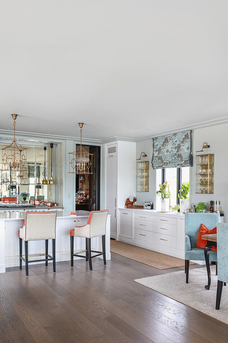 Elegant, white, open-plan kitchen with island counter